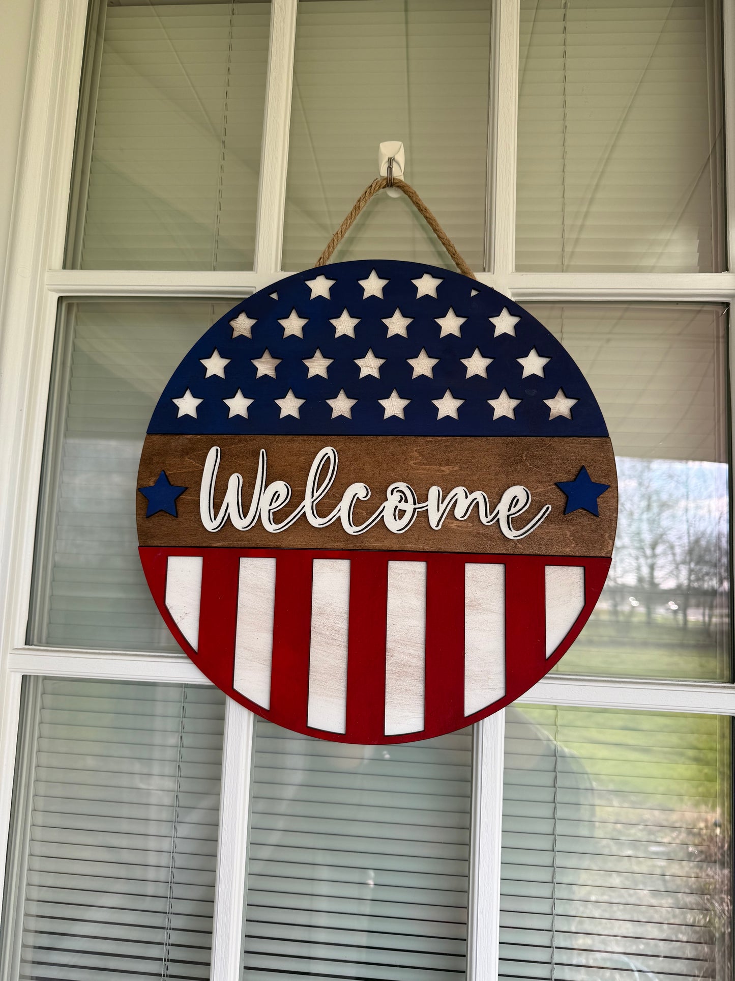 Red white and blue welcome sign